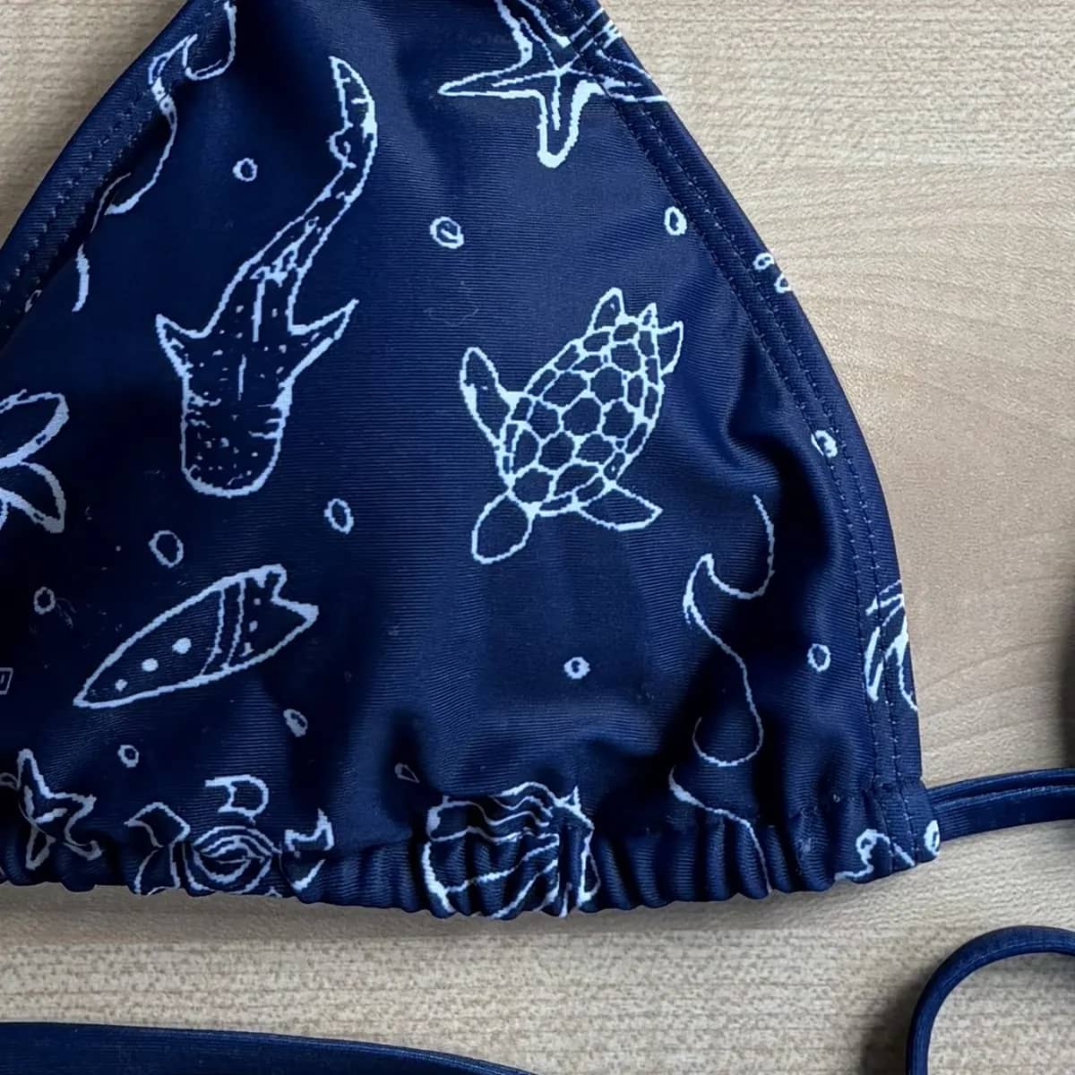 Close-up of the hand-drawn print on the Oceania bikini top